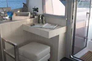 Isola Yacht Photos Pics 2018 Leopard 40 yacht interior with desk, chair, and window view.