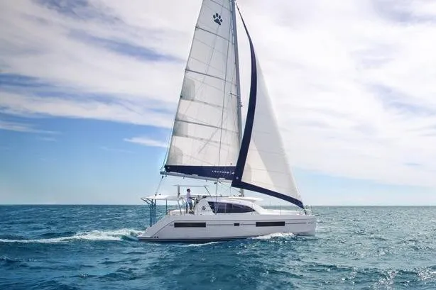 2018 Leopard 40 catamaran sailing on open sea under clear skies.