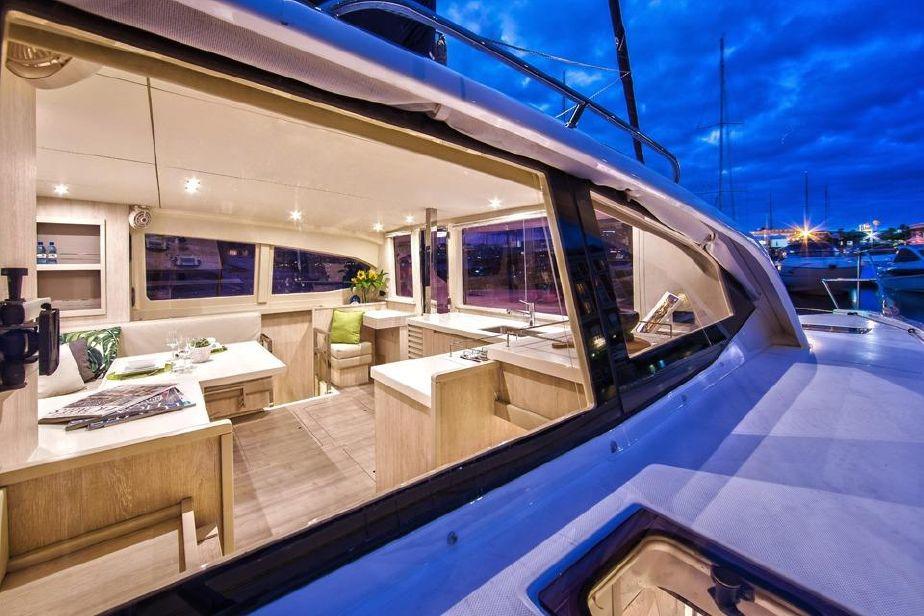 Luxurious interior of 2018 Leopard 40 catamaran at dusk, showcasing modern design and comfort.