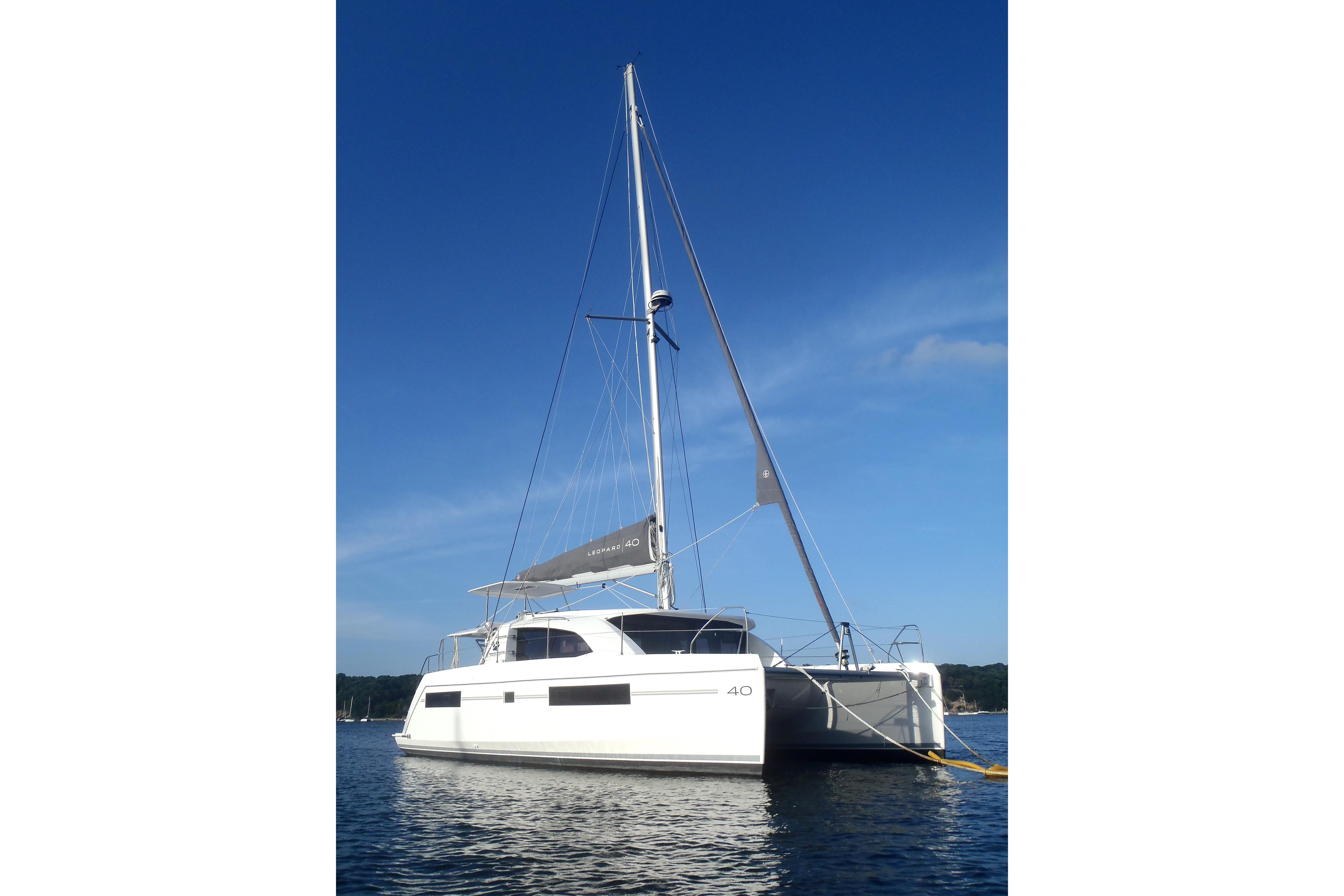2018 Leopard 40 catamaran sailing on calm waters under clear blue sky.
