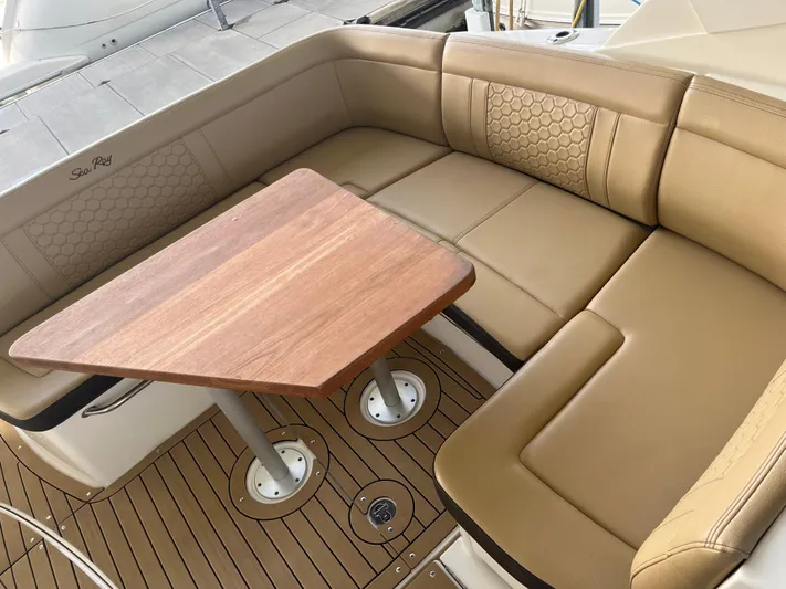 Lady Faby Yacht Photos Pics 2019 Sea Ray Sundancer 350 interior with tan seating and wooden table.