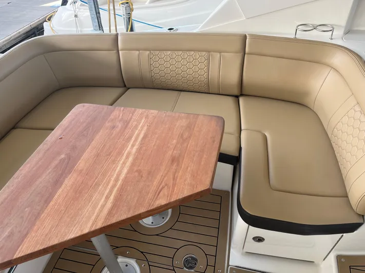 Lady Faby Yacht Photos Pics 2019 Sea Ray Sundancer 350 interior with beige seating and wooden table.