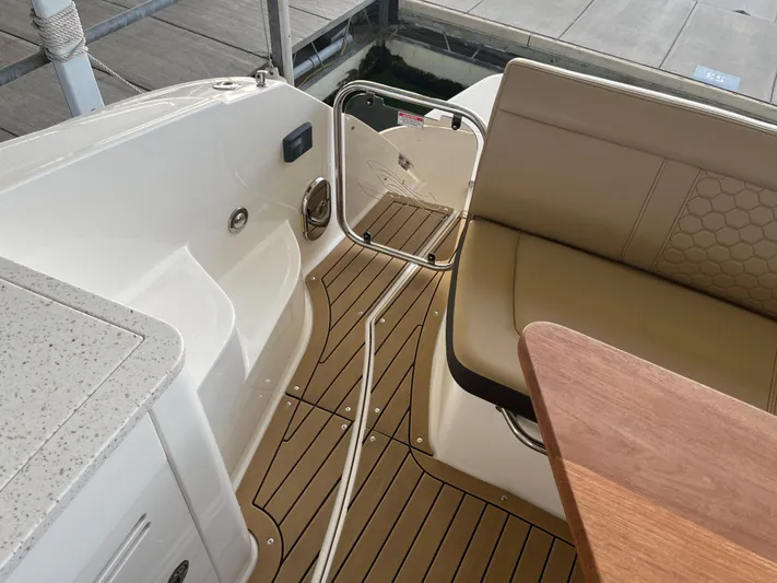 Lady Faby Yacht Photos Pics 2019 Sea Ray Sundancer 350 interior with seating, wooden table, and deck flooring.