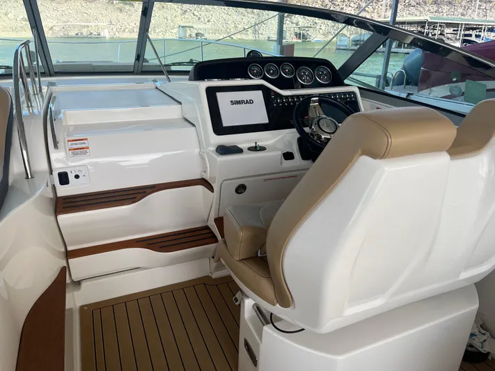 Lady Faby Yacht Photos Pics 2019 Sea Ray Sundancer 350 helm with Simrad display and beige seating.