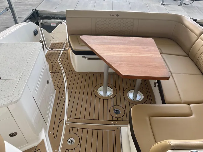 Lady Faby Yacht Photos Pics 2019 Sea Ray Sundancer 350 interior with tan seating and wooden table.