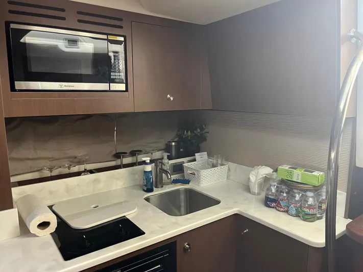 Lady Faby Yacht Photos Pics 2019 Sea Ray Sundancer 350 yacht kitchen with microwave, sink, and countertop essentials.