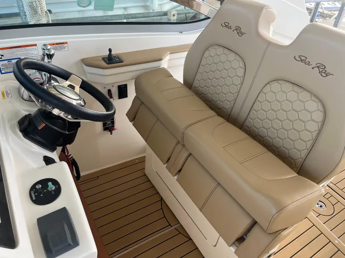 Lady Faby Yacht Photos Pics 2019 Sea Ray Sundancer 350 helm with beige leather seats and wooden flooring.