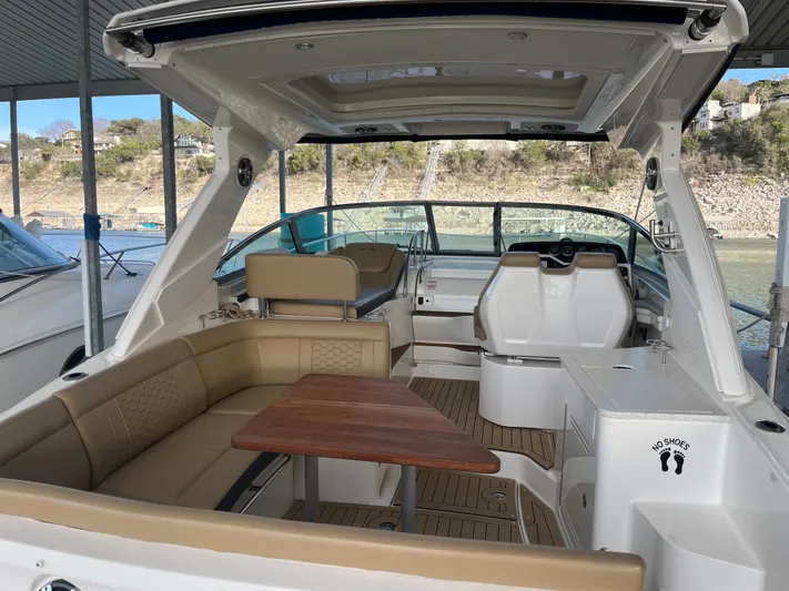 Lady Faby Yacht Photos Pics 2019 Sea Ray Sundancer 350 interior with tan seating and wooden table.