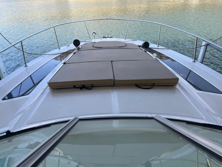Lady Faby Yacht Photos Pics 2019 Sea Ray Sundancer 350 yacht with sunpad on deck, overlooking calm water.
