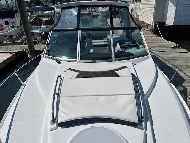  Yacht Photos Pics 2022 Monterey 295 Sport Yacht docked, showcasing sleek design and spacious deck.