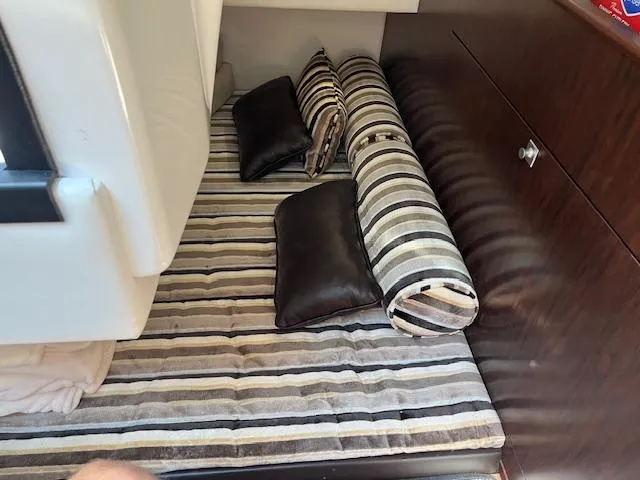  Yacht Photos Pics 2022 Monterey 295 Sport Yacht interior with striped cushions and pillows in cabin.