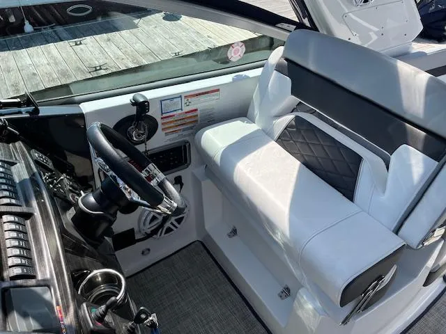  Yacht Photos Pics 2022 Monterey 295 Sport Yacht cockpit with modern steering and seating.