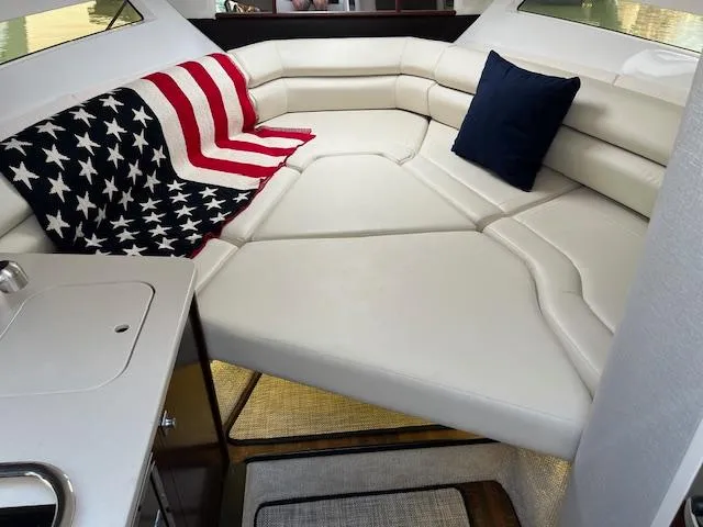  Yacht Photos Pics 2022 Monterey 295 Sport Yacht interior with American flag blanket and white seating.