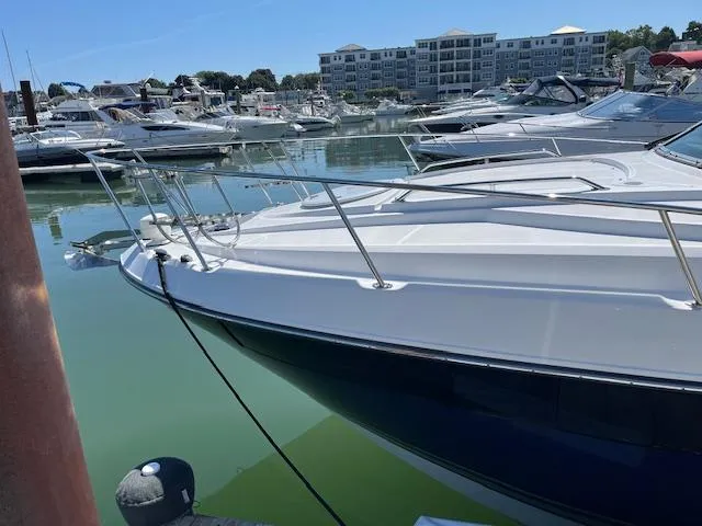  Yacht Photos Pics 2022 Monterey 295 Sport Yacht docked in a marina with other boats.