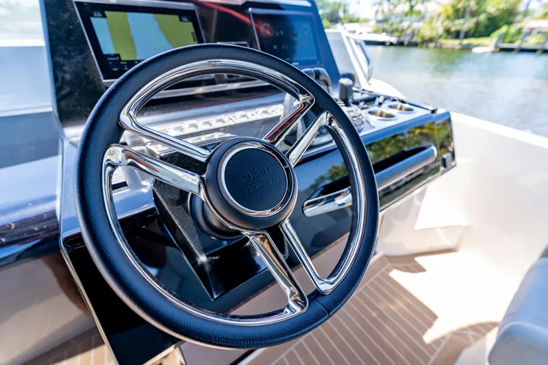  Yacht Photos Pics Steering wheel of 2024 Solaris Power 40 Open yacht, featuring modern dashboard controls.