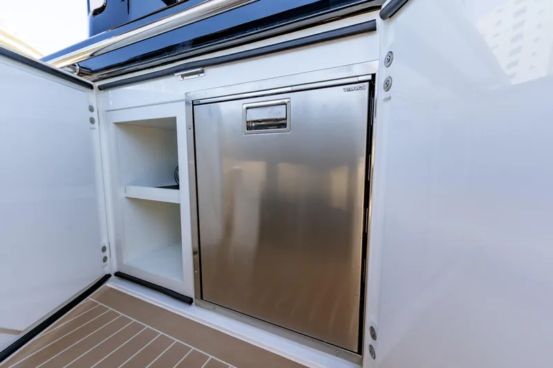  Yacht Photos Pics 2024 Solaris Power 40 Open yacht interior with stainless steel fridge and storage shelves.