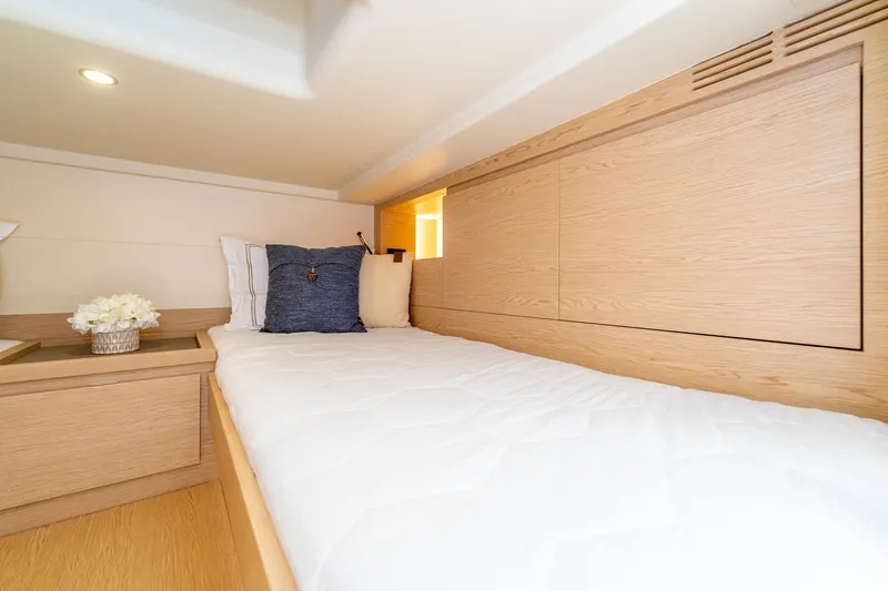  Yacht Photos Pics 2024 Solaris Power 40 Open cabin with modern wood interior and cozy bedding.