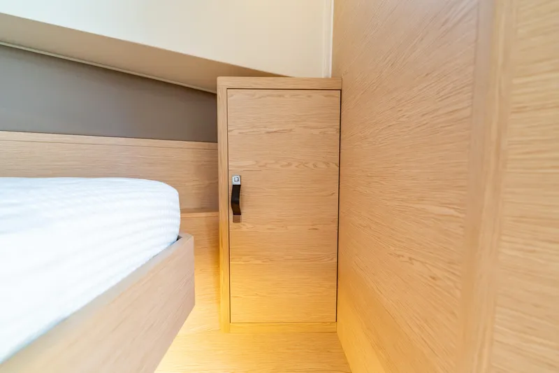  Yacht Photos Pics 2024 Solaris Power 40 Open interior with wooden cabinet and bed.