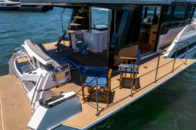 Da Mare Yacht Photos Pics 2023 OKEAN 52 yacht with spacious deck and modern seating on the water.