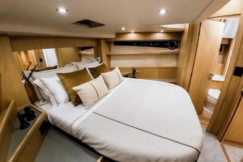 Da Mare Yacht Photos Pics Luxurious cabin interior of 2023 OKEAN 52 yacht with elegant bedding and modern design.