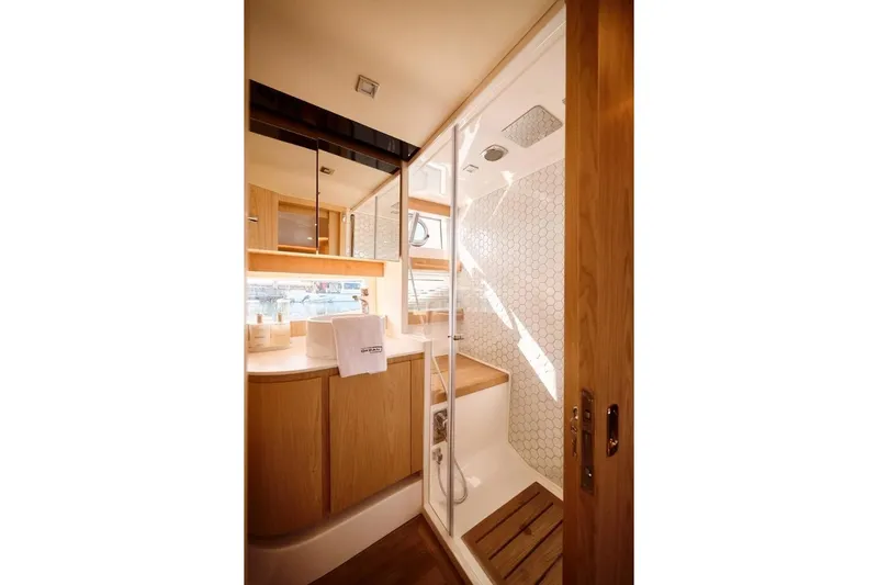 Da Mare Yacht Photos Pics Luxurious bathroom in 2023 OKEAN 52 yacht with modern shower and wooden accents.
