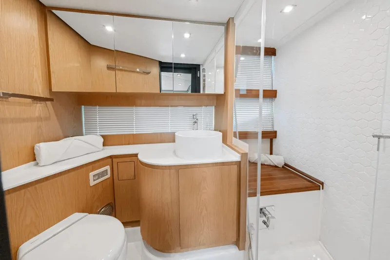 Da Mare Yacht Photos Pics Luxurious bathroom interior of 2023 OKEAN 52 yacht with modern wood and white design.