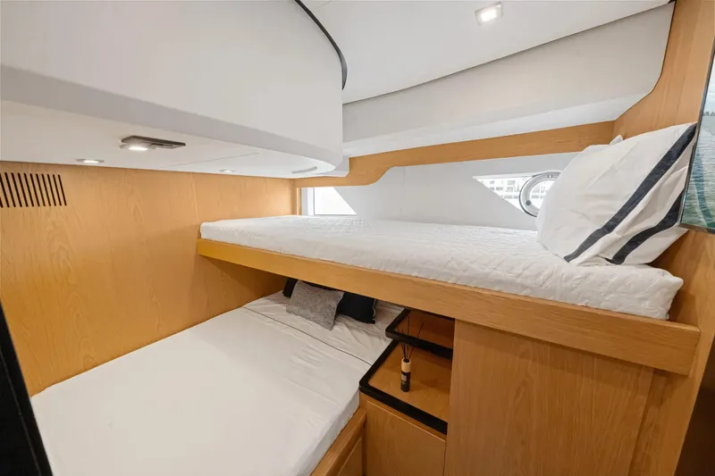 Da Mare Yacht Photos Pics Modern bunk beds in 2023 OKEAN 52 yacht cabin with wooden accents and porthole window.