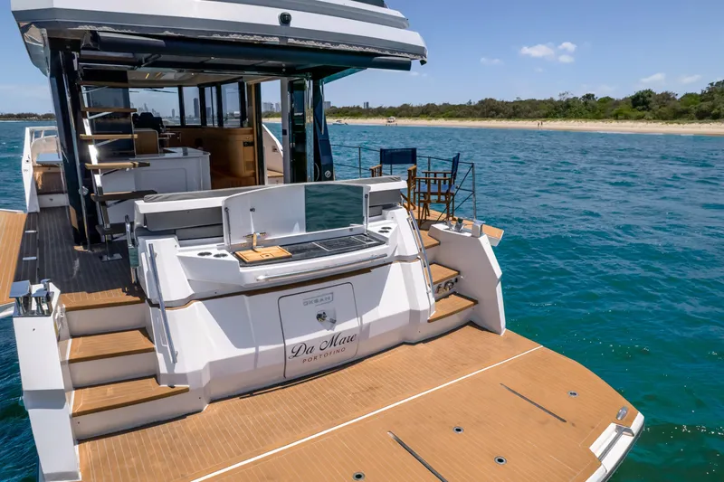 Da Mare Yacht Photos Pics Luxury 2023 OKEAN 52 yacht with spacious deck and modern amenities on the water.