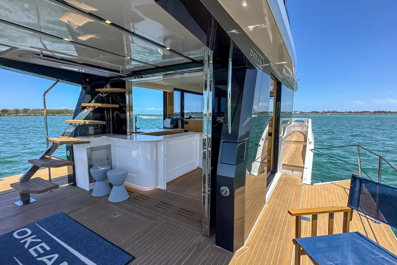 Da Mare Yacht Photos Pics Luxurious 2023 OKEAN 52 yacht with modern interior and scenic ocean view.
