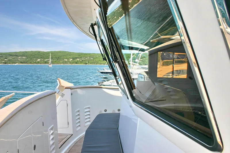  Yacht Photos Pics Luxury yacht Selene 66, 2026 model, cruising on serene blue waters with scenic green hills.