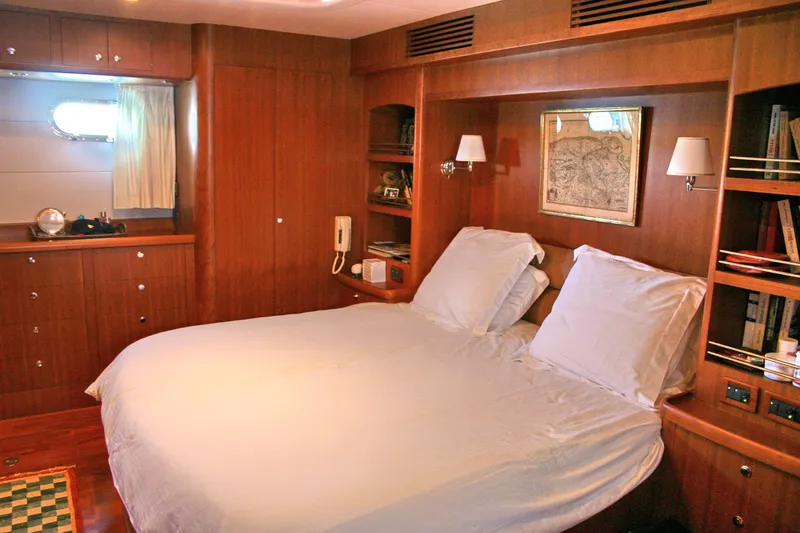  Yacht Photos Pics Luxurious cabin interior of 2026 Selene 66 yacht with cozy bed and wooden furnishings.