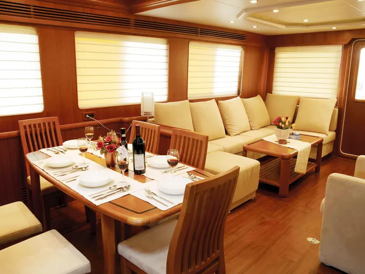  Yacht Photos Pics Luxurious Selene 66 yacht interior with elegant dining setup, cozy seating, and warm lighting, 2026 model.