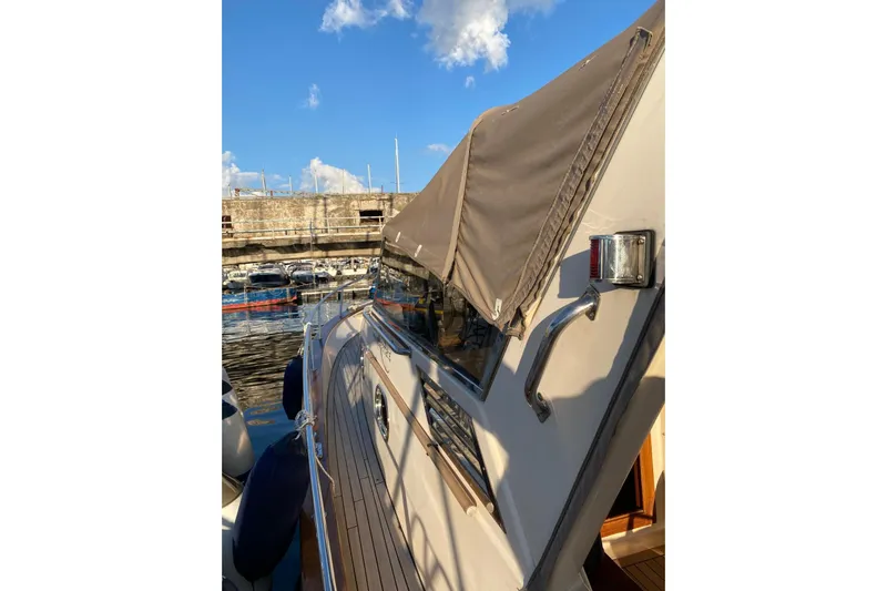  Yacht Photos Pics 2001 Apreamare Smeraldo 9 yacht docked, featuring sleek design and covered deck.