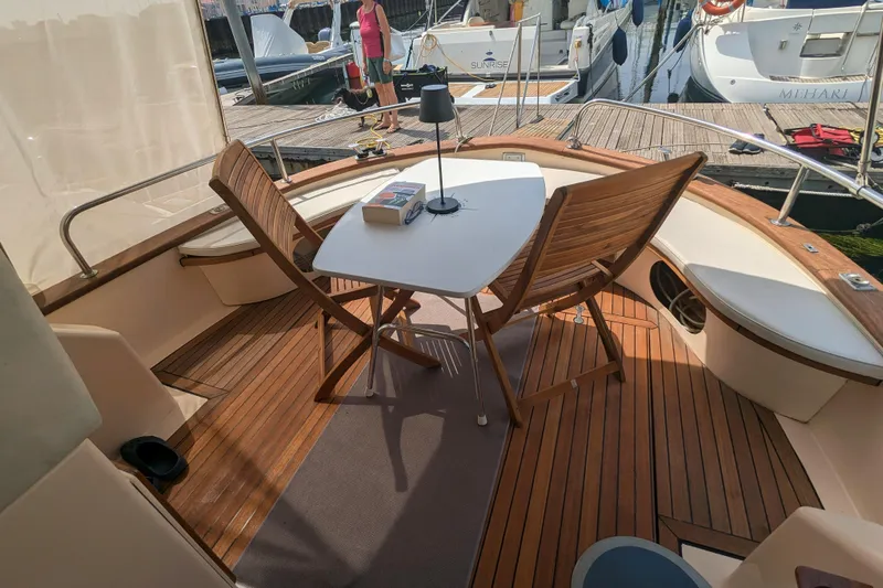  Yacht Photos Pics 2001 Apreamare Smeraldo 9 yacht deck with wooden chairs and table.