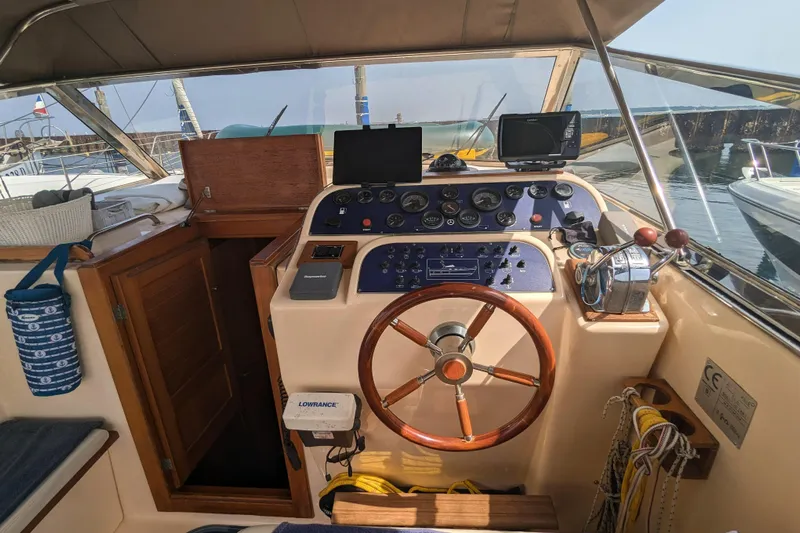  Yacht Photos Pics 2001 Apreamare Smeraldo 9 boat cockpit with wooden steering wheel and navigation instruments.