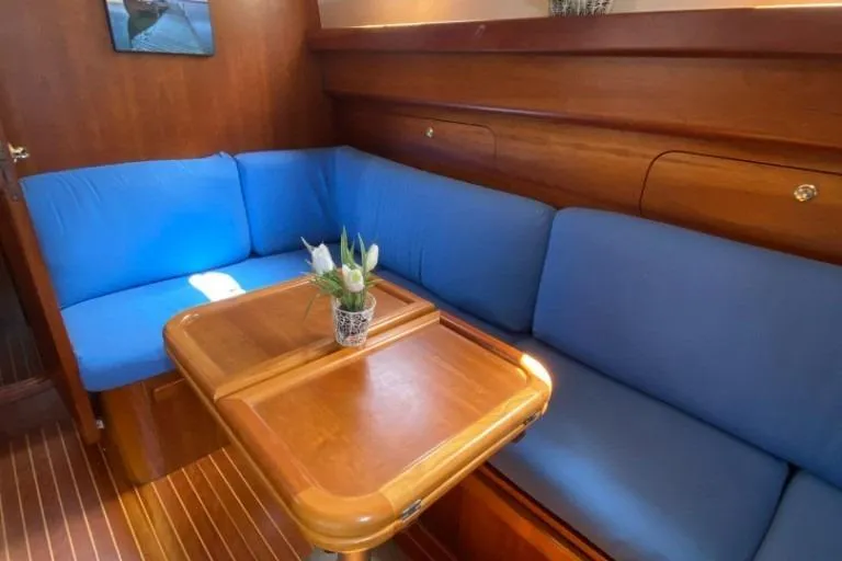  Yacht Photos Pics Interior of 2001 Apreamare Smeraldo 9 with blue seating and wooden table.