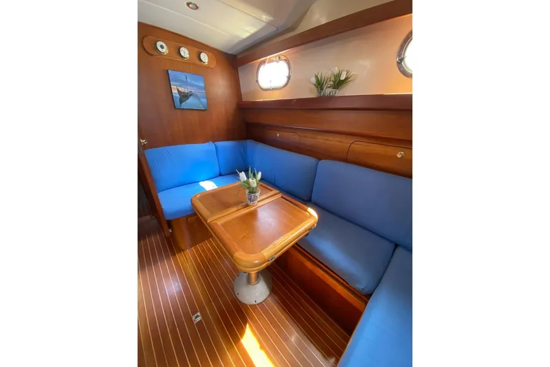  Yacht Photos Pics Luxurious 2001 Apreamare Smeraldo 9 yacht interior with blue seating and wooden table.