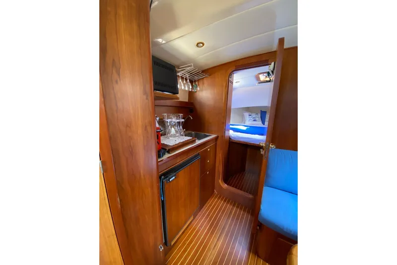  Yacht Photos Pics Interior of 2001 Apreamare Smeraldo 9 yacht with wooden cabinetry and cozy seating.