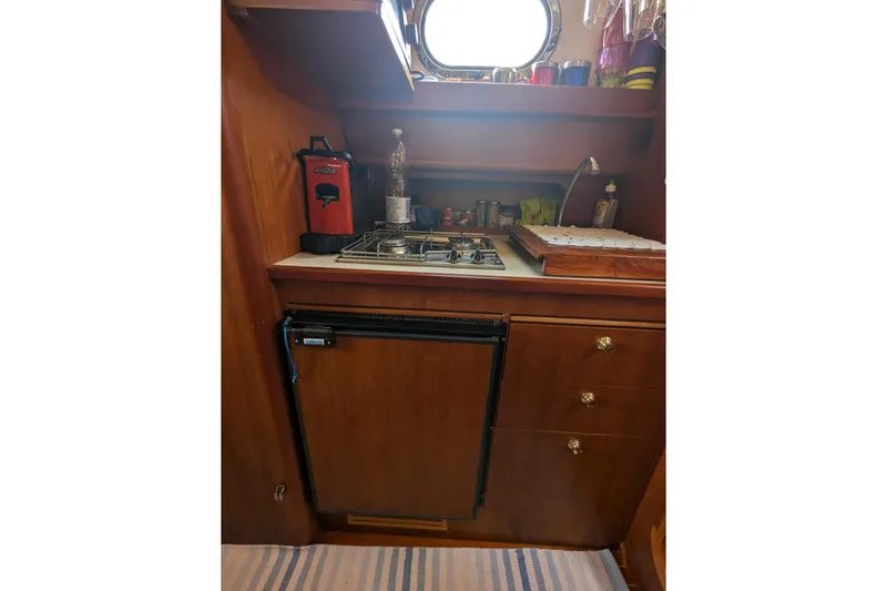  Yacht Photos Pics 2001 Apreamare Smeraldo 9 yacht kitchen with stove, fridge, and wooden cabinetry.