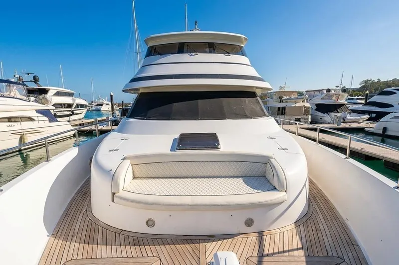 Angelina Yacht Photos Pics Luxury Monte Fino 73 yacht, 2005 model, docked in marina under clear blue sky.