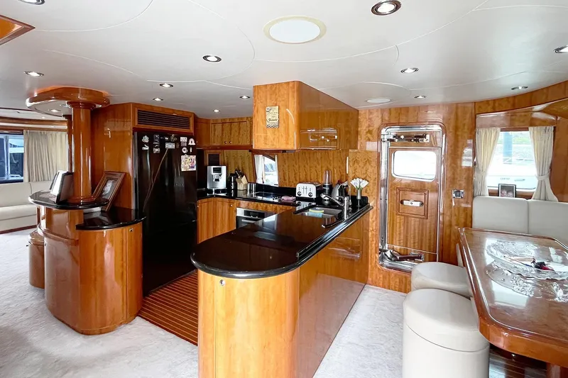Angelina Yacht Photos Pics Luxurious 2005 Monte Fino 73 yacht interior with elegant wood finishes and modern kitchen amenities.