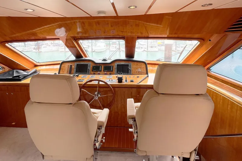 Angelina Yacht Photos Pics Luxurious helm of 2005 Monte Fino 73 yacht with leather seats and wooden dashboard.