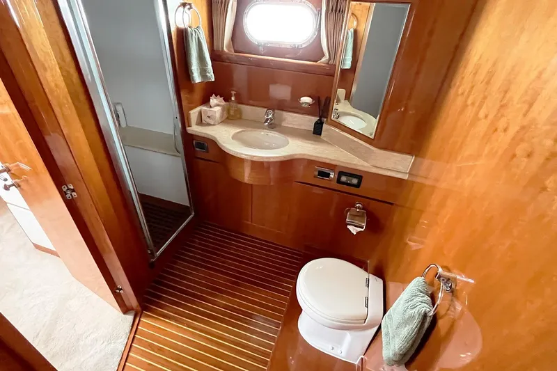 Angelina Yacht Photos Pics Luxurious bathroom in 2005 Monte Fino 73 yacht with wooden finishes and modern amenities.