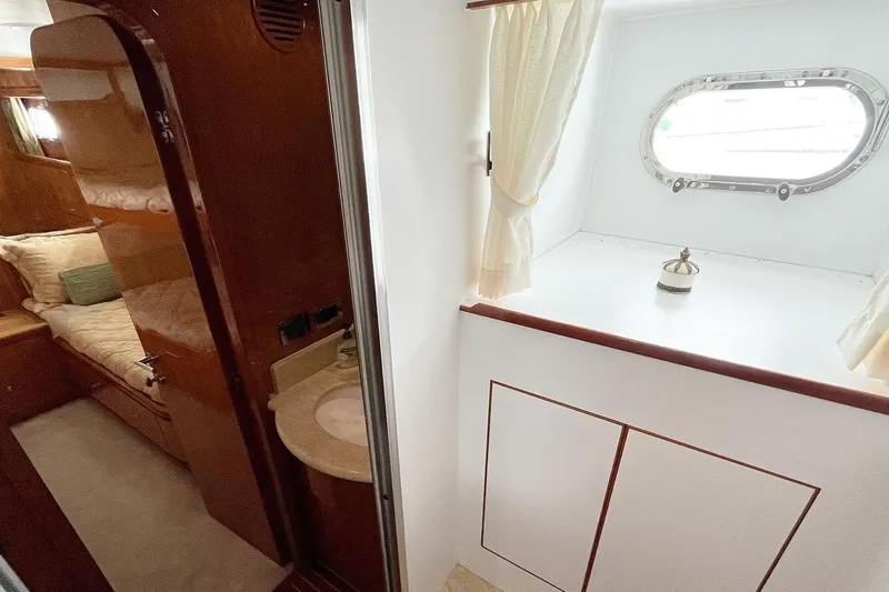 Angelina Yacht Photos Pics Interior of 2005 Monte Fino 73 yacht, featuring a cozy cabin and porthole window.