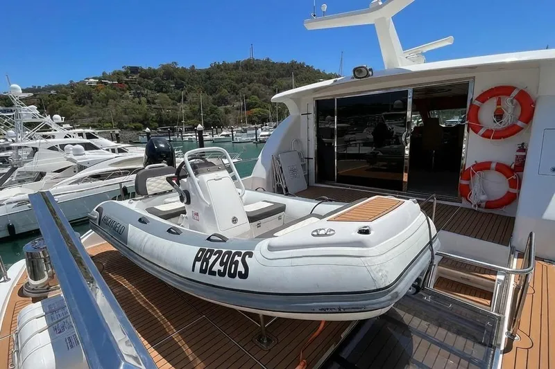 Angelina Yacht Photos Pics 2005 Monte Fino 73 yacht with inflatable boat on deck, docked at marina.