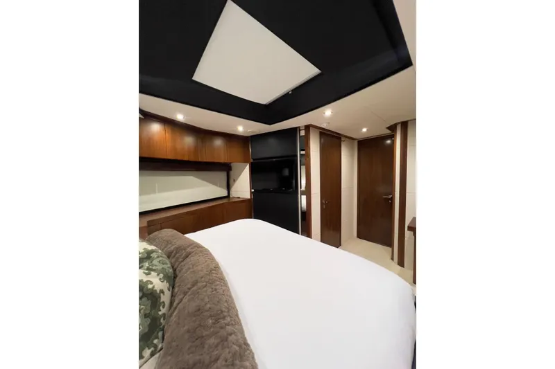 Ohana Yacht Photos Pics Luxurious bedroom interior of 2012 Sunseeker Manhattan 73 yacht with elegant wood finishes.