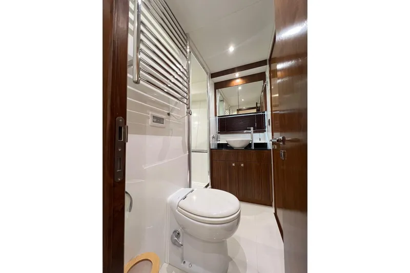 Ohana Yacht Photos Pics Luxurious bathroom interior of 2012 Sunseeker Manhattan 73 yacht, featuring modern fixtures and wood accents.