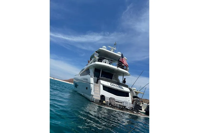 Ohana Yacht Photos Pics 2012 Sunseeker Manhattan 73 yacht on water, clear sky, rear view.