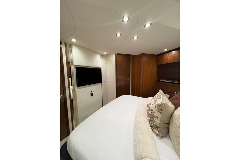 Ohana Yacht Photos Pics Luxurious bedroom interior of 2012 Sunseeker Manhattan 73 yacht with elegant wood finishes.