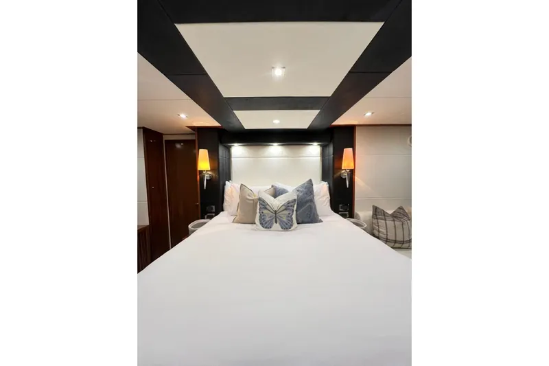 Ohana Yacht Photos Pics Luxurious bedroom interior of 2012 Sunseeker Manhattan 73 yacht with elegant lighting and decor.